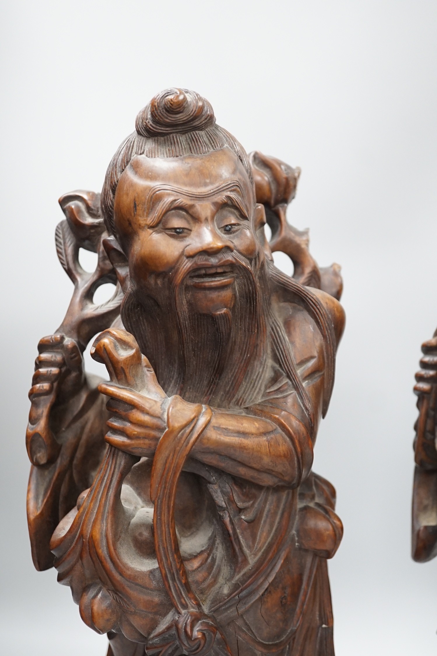 Two Chinese hardwood figures of luohans, early 20th century Tallest 48cm